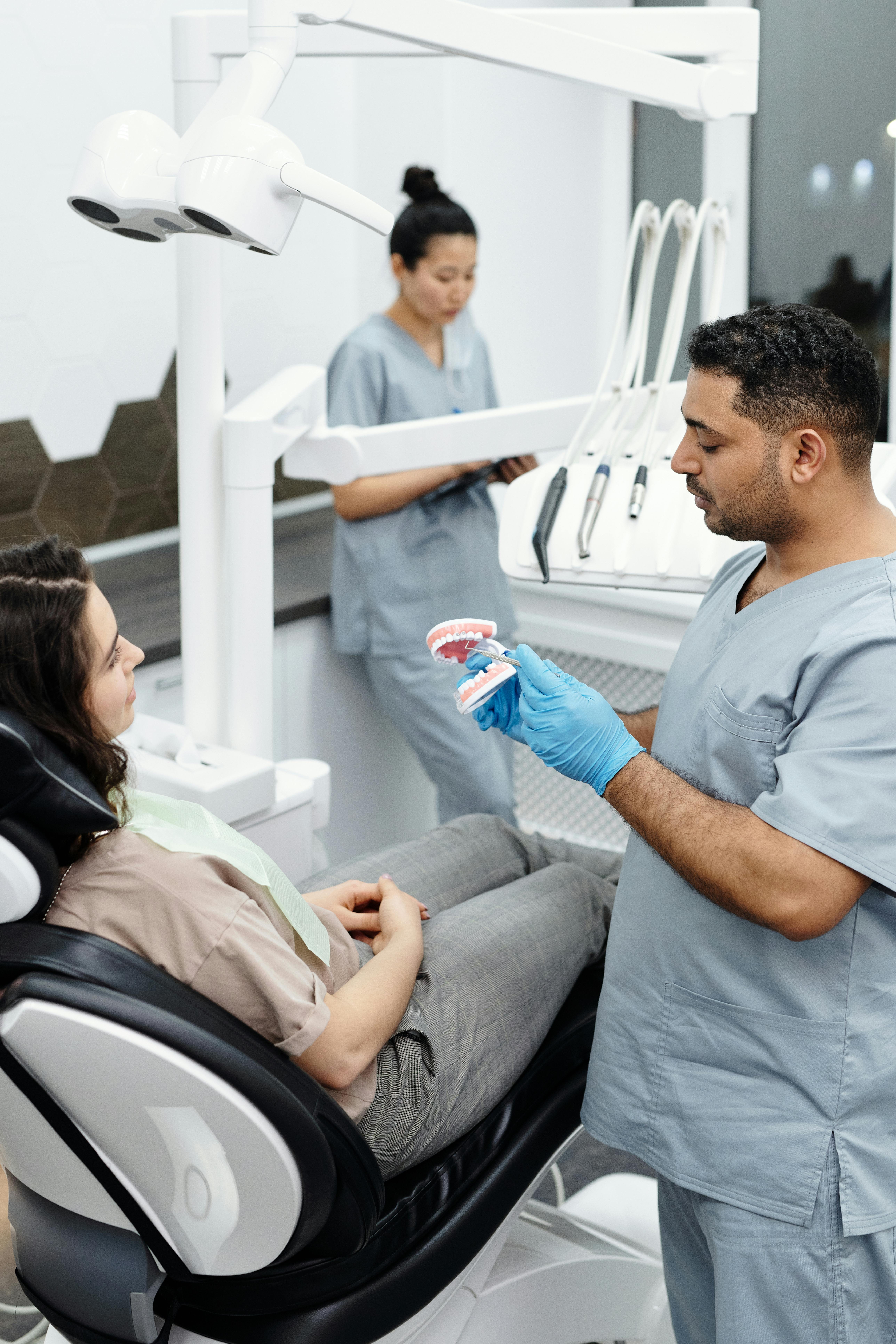 Dentist consulting with patient
